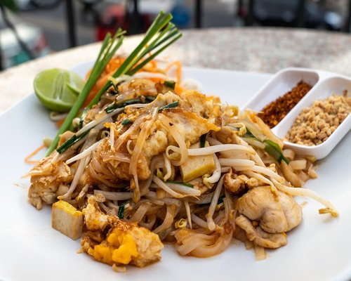 Thai street food vendor cooking fresh pad thai